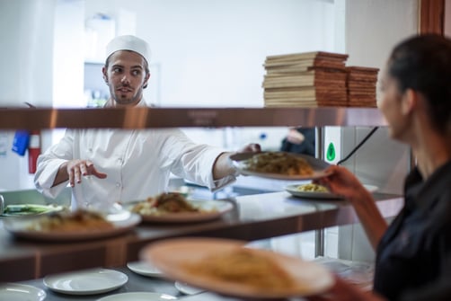 waitress-taking-meal-off-kitchen-counter-for-custo-2024-11-03-04-29-04-utc